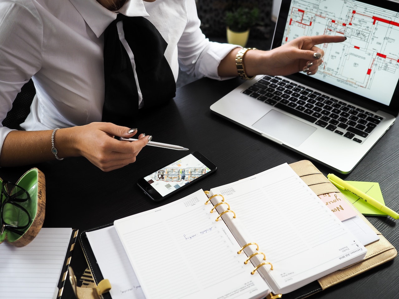 Person confidently managing finances with laptop and budget spreadsheet