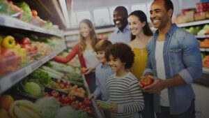 Happy diverse family shopping for fresh produce in a grocery store.